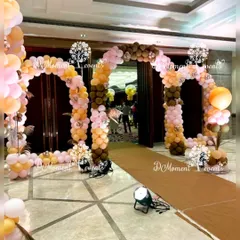 A double balloon arch entrance in a chic brown, peach, and pink color scheme, perfect for a modern and stylish Boho-themed celebration.