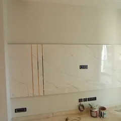 The TV panel during installation, showing the raw materials before the final finishes are applied.