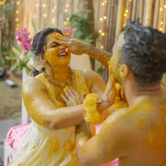 The groom playfully applying haldi to his bride. This ceremony is all about love, blessings, and a lot of fun.