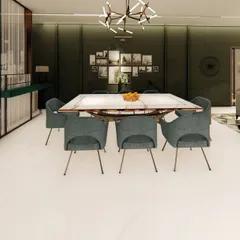 In this open-plan home, the dining area is defined by a dark green accent wall and a large, rustic dining table. The space is designed to feel connected to the living area, perfect for large gatherings.