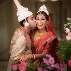 The vibrant colors and infectious happiness of a traditional Bengali wedding. I love capturing the unique cultural rituals and candid joy of all types of ceremonies. This photo is full of life, from the couple's expressions to the beautiful floral details.