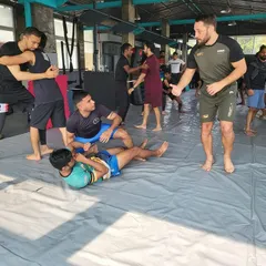 Hands-on instruction is key to our method. Here, a guest instructor provides real-time feedback during a drilling session, ensuring that every student understands the mechanics of the technique being taught.