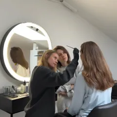 We keep our classes small to give you our full attention. In this photo, an instructor is demonstrating the correct brush technique for eyebrow coloring, while a student observes closely. This personalized approach is key to building confidence and skill.