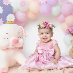This 6-month-old princess is all smiles with her giant piggy friend. My studio has lots of fun props to make your baby's milestone shoot special.