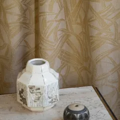 The "Ami" semi-sheer curtain by Nobilis, crafted from 100% hemp. Its intricate weave, inspired by Japanese bamboo basketry, allows for a beautiful diffusion of light while adding a layer of natural, artisanal texture to the space.