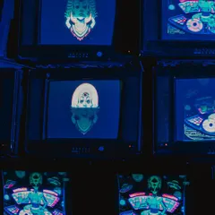 An installation of stacked vintage television sets displaying psychedelic, custom-made visuals. This retro-tech art piece was a major focal point and conversation starter.