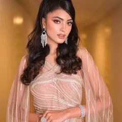 A confident and powerful pose. The high ponytail and sharp makeup give off a high-fashion vibe, perfect for the bride who wants to make a statement.