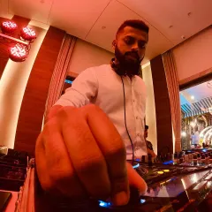 It's all in the details. A close-up of me fine-tuning the mix, making sure every transition is perfect to keep the energy flowing on the dance floor.