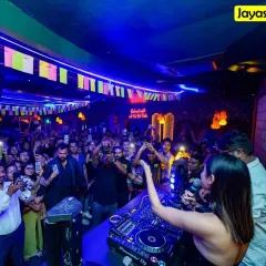 A view from my console as actress Mouni Roy and I hype up a massive crowd. My goal is to connect with the audience, making them part of the show and creating a shared, high-energy experience.