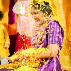 The bride's pure, uninhibited laughter as she's showered with flowers. These are the candid, joyful moments that make haldi so special.