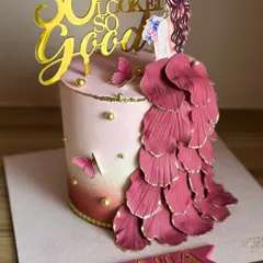 This elegant stunner was made for a queen celebrating her 50th birthday. The design features a flowing gown of hand-shaped petals, blush tones, and a "50 never looked so good" topper.