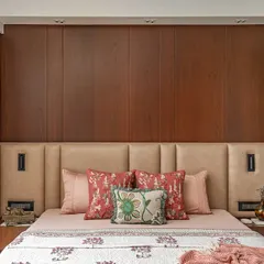 Natural light and warm wood tones define this master bedroom from our 'Oak Lodge' project. The custom leather headboard and integrated focus lights create a serene and timeless sanctuary, proving that elegance lies in simplicity and quality craftsmanship.