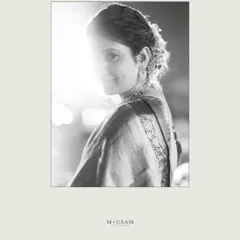 An artistic black and white bridal portrait. The strong backlight creates a beautiful silhouette effect, while she gives a subtle glance towards the camera. It’s a simple, yet powerful and magical frame.