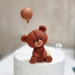 A close-up of the handmade fondant teddy bear topper. I love adding texture and small details to bring these little characters to life.