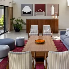A different perspective of the living space, showing how we use furniture and art to define areas within an open-plan layout. The clean lines of the console and the modern art triptych add a layer of curated sophistication.