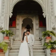 A majestic portrait in front of a heritage property. For destination weddings in places like Jaipur, we use the stunning architecture as a backdrop for regal photos.