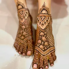 Reshma's bridal feet mehendi, a masterpiece of traditional Indian design with lotus flowers, paisleys, and intricate netting.