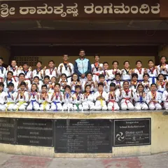 A large group photo of our students and instructors after a successful event. The mix of different colored belts on display shows the path of progression available to everyone at the academy.