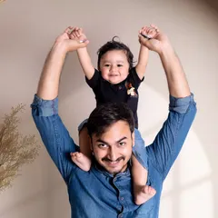 The special bond between a father and his son. This joyful photo captures a classic piggyback ride, full of smiles and happiness, taken in my studio.