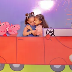 A heartwarming moment at a Peppaland party, where two little princesses share a hug inside the custom Peppa Pig car photo booth. These are the precious memories I love to help create.