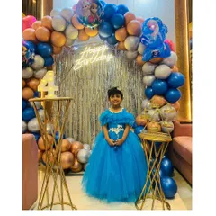 This little girl is celebrating her 4th birthday in a Frozen-themed blue princess gown I created for her.