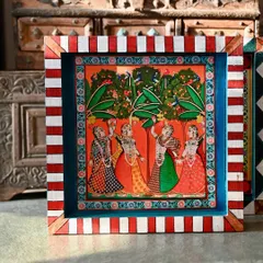 The bottom block of the set, showing gopis in a lush grove. The red and white striped border adds a playful, contemporary touch.