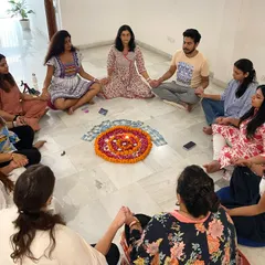 A full moon meditation circle holding hands. The energy of the full moon is a potent time for release and reflection, and practicing in a community amplifies its effects.