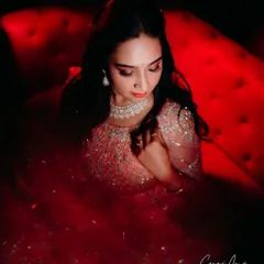This artistic shot uses dramatic red lighting to create a high-fashion feel. I designed the makeup with enough definition and glow to look stunning even under creative and colorful lighting conditions, perfect for a reception party.