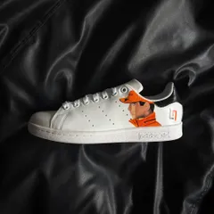 A side profile of the other shoe, featuring a detailed portrait of Lando Norris in his McLaren gear.