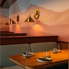 The details make the difference. Our wall murals and custom brass light fixtures add a layer of artistry to the dining experience, providing a beautiful and unique backdrop for your event photos.