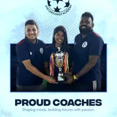"Proud coaches." Three of our coaches holding a championship trophy, a symbol of their collective effort and passion for building winning teams.