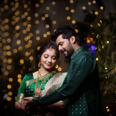 A tender moment between the couple during their engagement celebration. The warm bokeh from the lights creates a dreamy and romantic atmosphere.