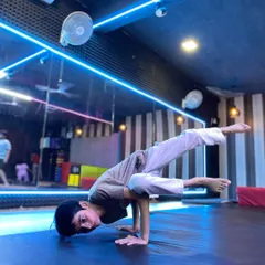 Strength and control are fundamental to our training. This student demonstrates an advanced hand balance, a skill developed through our specialized gymnastics for dancers program.