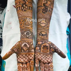 This custom bridal henna features a variety of meaningful symbols. You can see a Ganesha for blessings, a peacock for beauty, and the couple's names hidden within the intricate patterns.