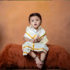 A tiny prince in traditional vibes, ready to rule the world with his cuteness.