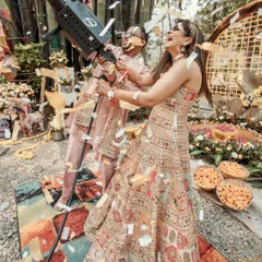 A playful moment from a Haldi ceremony, where the couple is showered with confetti from a party cannon. It's all about capturing the fun and unique elements of your celebration.