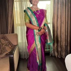 Adorned in tradition and wrapped in grace. This bride shines in a rich purple Paithani saree with a contrasting green and gold border, perfectly draped for her special day.