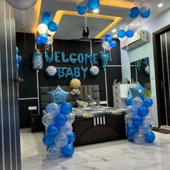 This is a complete bedroom decoration for a baby boy's welcome. It includes "WELCOME BABY" foil balloons over the bed, balloon pillars, and other baby-themed foils to make the room special for the new parents.