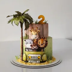 A charming two-tiered jungle safari cake for a 2nd birthday. This design features cute fondant animals in a jeep, complete with a handcrafted palm tree for a fun adventure theme.