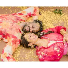 After all the fun and chaos, a quiet moment of togetherness. The couple lies down amidst the scattered marigold petals, smiling, a beautiful and artistic end to their vibrant Haldi ceremony.