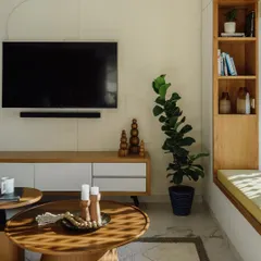 This living room setup features a set of two solid wood coffee tables and a sleek, minimal TV console I built. The round tables have a sturdy pedestal base, offering a modern look that complements the room's calm aesthetic.