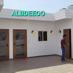 The exterior of a prefab office we built. The clean white cladding, wooden doors, and modern lighting create a professional and welcoming entrance for any business.