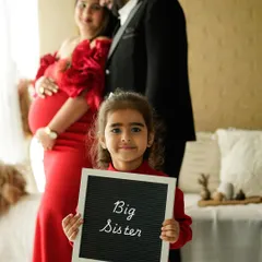 Welcoming a new baby is a joy for the whole family. We love capturing the excitement of siblings, like in this sweet "Big Sister" announcement.