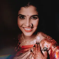 A radiant bridal portrait. The bride's genuine, happy smile is infectious, and the lighting beautifully captures the glow on her face and the sparkle of her jewellery.