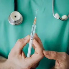 A clinician preparing a syringe for a PRP for skin treatment. In this procedure, we use the platelet-rich plasma from your own blood to repair and enhance your skin.