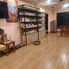 A view of our reception and product display area. We maintain a calm and professional environment, with traditional elements like the brass lamp and deity artwork creating a space of positive energy.