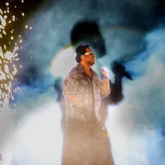 An artistic shot using smoke and backlighting to create a powerful silhouette effect behind the performer. This photo highlights our creative approach to live event photography.