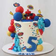 Your friendly neighborhood Spider-Man swings into the party with this action-packed cake. It's a vibrant design with a Spidey figure, comic book-style "POW!" and "BAM!" toppers, and colorful spheres.