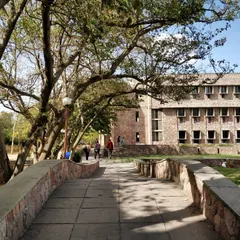 A stone causeway on the campus acts as a bridge and a dam to impound rainwater. This feature helps recharge the local water table and adds to the unique environmental character of the university.
