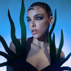A close-up from a beauty editorial focused on creating a surreal, aquatic-inspired look. I used specific studio lighting with blue gels to craft this otherworldly mood, highlighting the sharp, graphic makeup and the model's intense gaze.